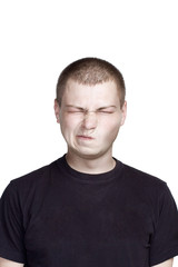 Fototapeta premium Portrait of young man. Facial expression. disgusting face.