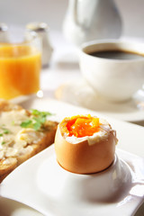 Brakfast table with soft boiled egg. Selective focus