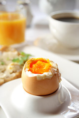 Brakfast table with soft boiled egg. Selective focus