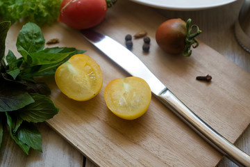 Vegetable salad with fresh lettuce, tomatoes and cucumber in clay pot. Top view.