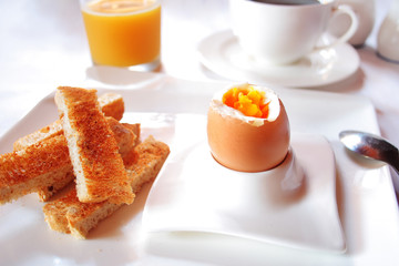 Brakfast table with soft boiled egg. Selective focus