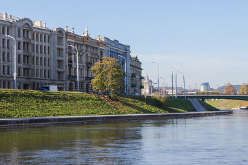 Fototapeta na wymiar The embankment of the Narva River and the bridge across this river in Vilnius. Lithuania