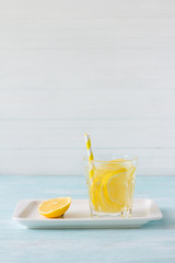 Lemon water in a glass on a white background. selective focus. healthy morning drink	