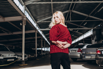 A stylish young girl, a doctor or a nurse poses for the advertising photography of a medical shirt for medical staff, comfortable and stylish clothes. urban clothing style. Street photography
