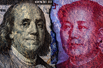 Closeup of cracked of Face to face of US dollar banknote and China Yuan banknote for 2 biggest economic in the world which now United states of America and China have war trade.Both countries conflict
