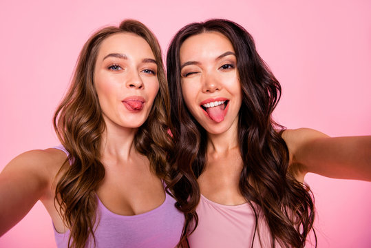 Close up photo of carefree funny funky cute charming ladies make faces photos have free time weekends fellows fellowship stylish trendy youth outfit long haircut isolated pink background