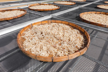 dried shredded pork on threshing basketdry with sunlight background