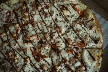 texture of pizza, close-up. Thin slices of sausage. Texture of hot traditional italian dish.