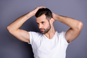 Fototapeta na wymiar Close up photo amazing he him his macho perfect appearance touch arm hand neat groomed head haircut calm not smiling look mirror bath empty space wear casual white t-shirt isolated grey background