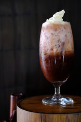 Iced coffee with milk on table