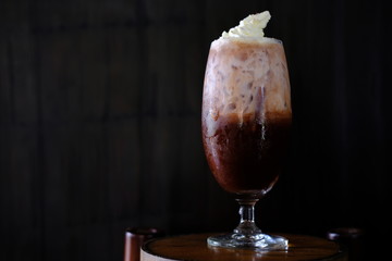 Iced coffee with milk on table