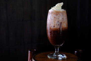 Iced coffee with milk on table