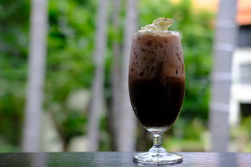 Iced coffee with milk on table
