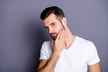 Close up photo amazing he him his macho perfect appearance touch arm hand neat bristle face calm not smiling ponder pensive look mirror bath shower wear casual white t-shirt isolated grey background