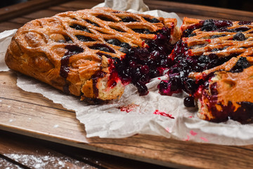 tasty bread on white paper on brown wooden board
