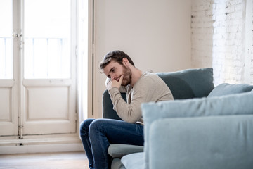 Fototapeta premium Young man suffering from depression hopeless and alone at home