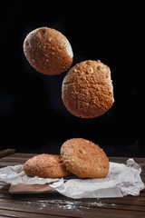 tasty bread on white paper on brown wooden board