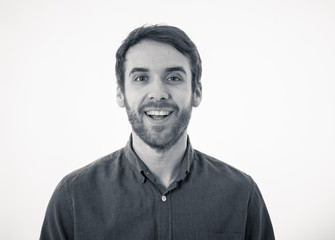 Portrait of attractive cheerful young man with smiling happy face. Human expressions and emotions