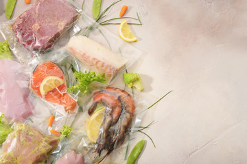 Sous Vide cooking concept. Vacuum packed ingredients arranged on light background. Top View.