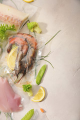 Sous Vide cooking concept. Vacuum packed ingredients arranged on light background. Top View.