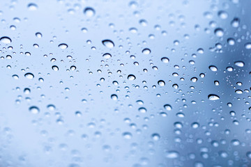 Water rain drops on glass surface background selective focus and shallow depth of field.