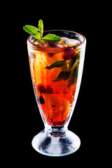 Fresh cold strawberry tea with ice and mint on black isolated background