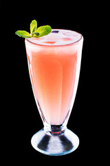 glass with fresh grapefruit summer alcohol cocktail, ice and mint on black isolated background