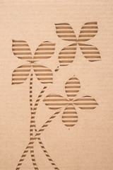 Fototapeta na wymiar Flower cut out on a corrugated cardboard 