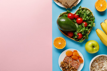 top view of diet food on blue and pink background with copy space