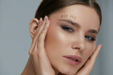 Beauty makeup. Woman face with messy eyebrow and fix me on skin