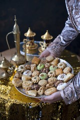 Oriental tea tray and cookies symbolising Moroccan hospitality, Islamic holidays food with...