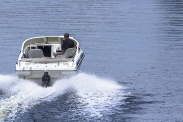 Motor boat in motion. White yacht. Travel by water on a speedboat. Holidays on a cruise on the sea...