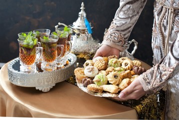 Oriental tea tray and cookies symbolising Moroccan hospitality, Islamic holidays food with...