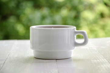 Fototapeta premium white cup of tea on a white table, close up