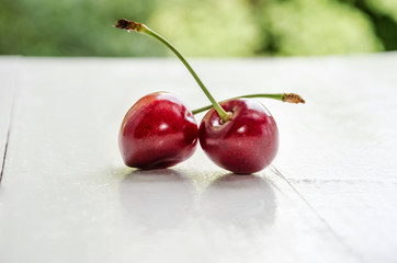 Sweet cherries on beautiful white table close up