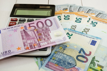 500 euro closeup, calculator and coins