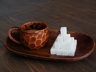 Sugar addiction concept shot of custom made clay espresso mug standing on oval plate with an...