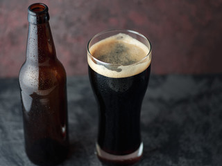 Beer bottle and glass with dark beer porter or stout