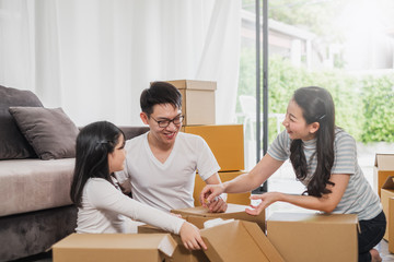 Asian family moving to new home/house and unpacking boxes