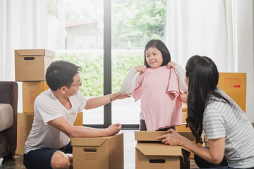 Asian family moving to new home/house and unpacking boxes