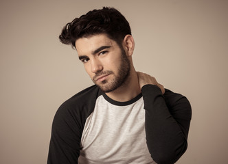 Fototapeta premium Fashion portrait of Attractive young manly man model posing happy and sexy for the camera
