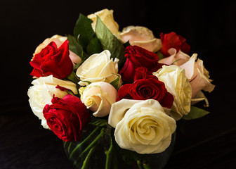 Bouquet of red and white roses on a black background