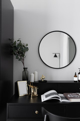 Black and white luxury feel dressing table corner in modern scandinavian style with gold circular lamp decorated / interior design concept / scandinavian interior