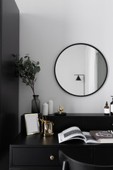 Black and white luxury feel dressing table corner in modern scandinavian style with gold circular...