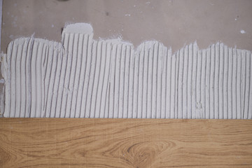 wood effect tiles on the floor. unfinished laying floor tiles