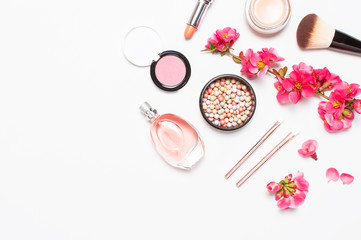 Naklejka premium Different makeup cosmetic. Ball blush rouge face powder lipstick concealer bottle of perfume eyeshadow makeup brush spring pink flowers on light background top view flat lay. Beauty fashion background