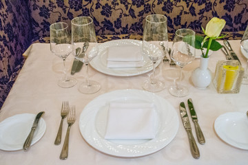 beautiful french restaurant interior with crystal chandeliers and table seating with china porcelain tableware