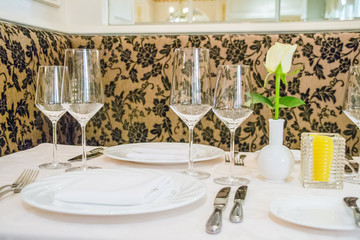 beautiful french restaurant interior with crystal chandeliers and table seating with china porcelain tableware