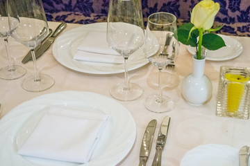 beautiful french restaurant interior with crystal chandeliers and table seating with china porcelain tableware