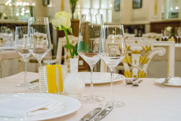 beautiful french restaurant interior with crystal chandeliers and table seating with china porcelain tableware